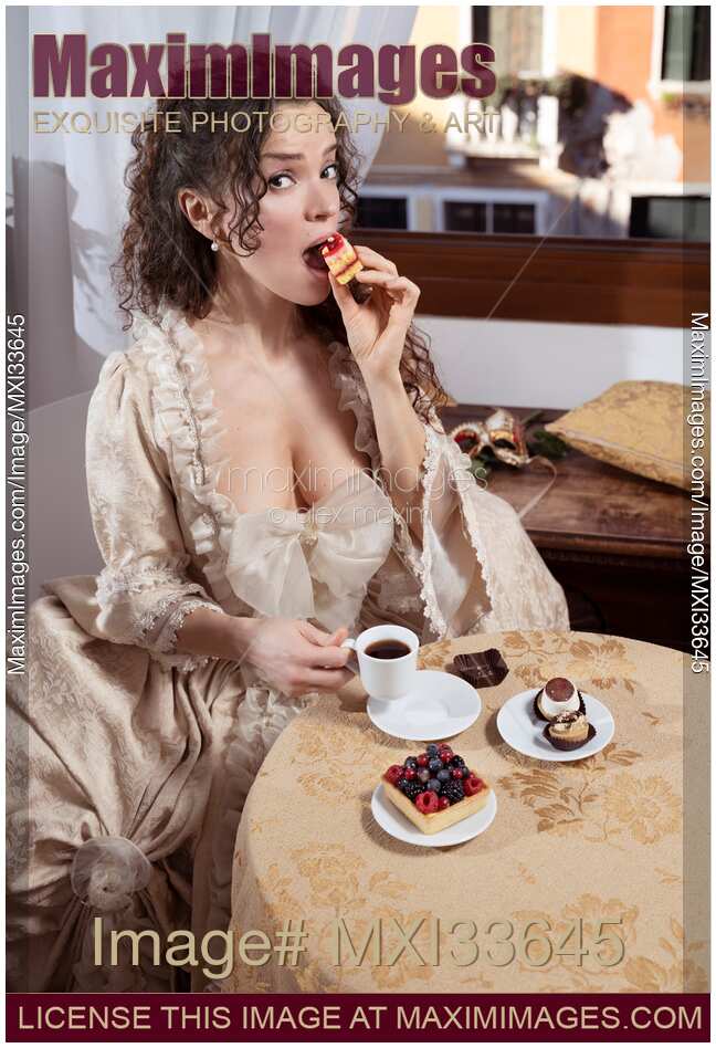 Woman in vintage Italian carnival dress eating tart pastry at café table with humorous capricious indulging expression