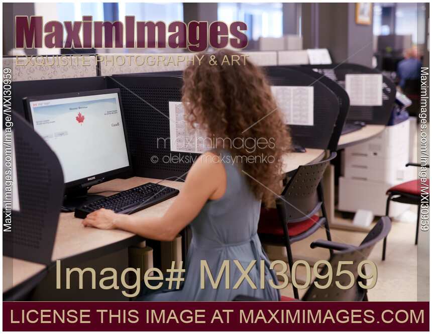 Woman is using a computer at Service Canada office