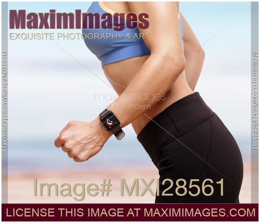 Woman jogging outdoors with Apple Watch on her wrist