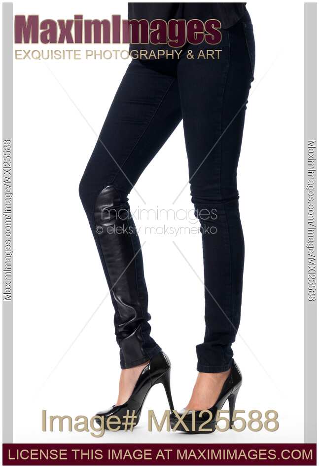 Woman legs in black jeans and high heel shoes