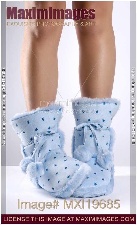 Woman legs in warm bootie slippers