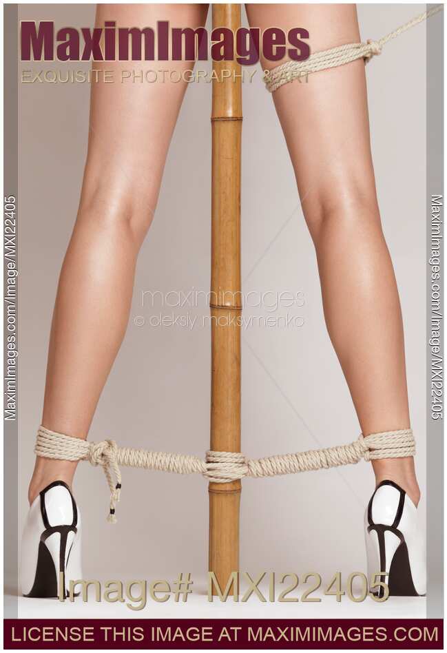 Woman Legs Tied With Ropes to Bamboo
