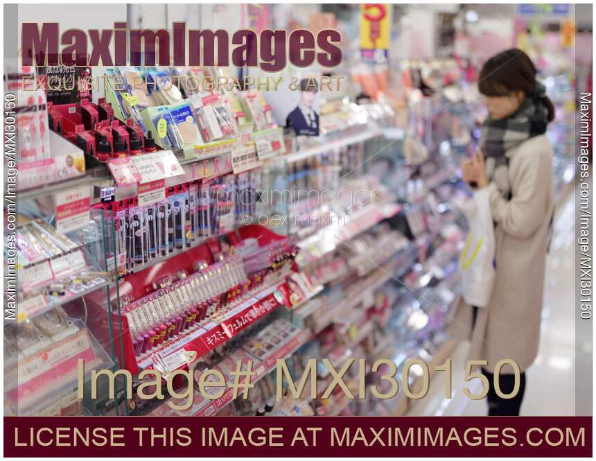 Photo of Woman looking at makeup display of Japanese beauty product