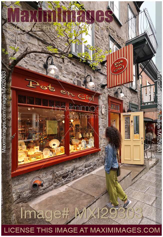 Woman looking at Pot en Ciel shop display on Rue du Petit Champlain historic street in Old Quebec City