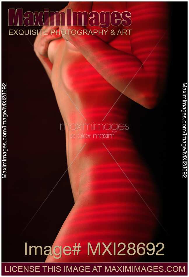 Woman naked body with red laser stripes on skin