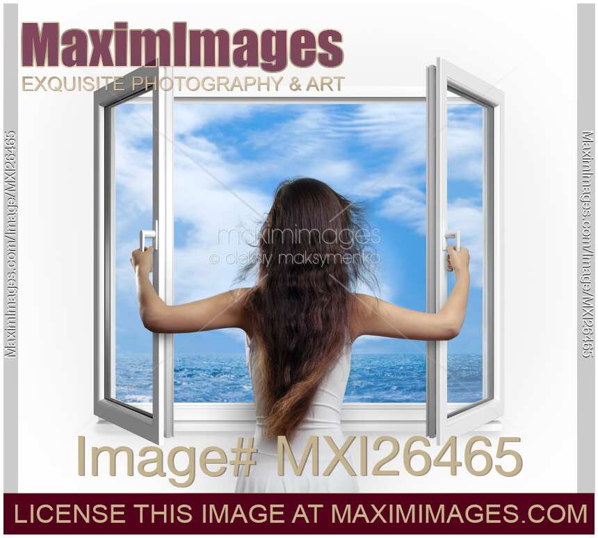 Woman opening window with view on sea