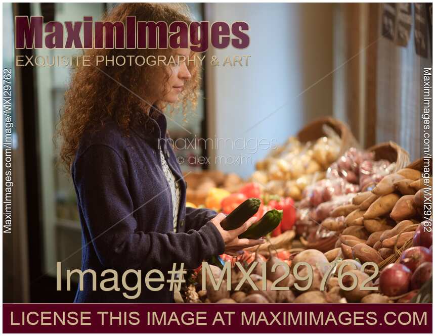 Woman picking fresh produce at a farm grocery store