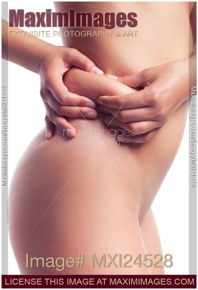 Woman pinching fat around her waist