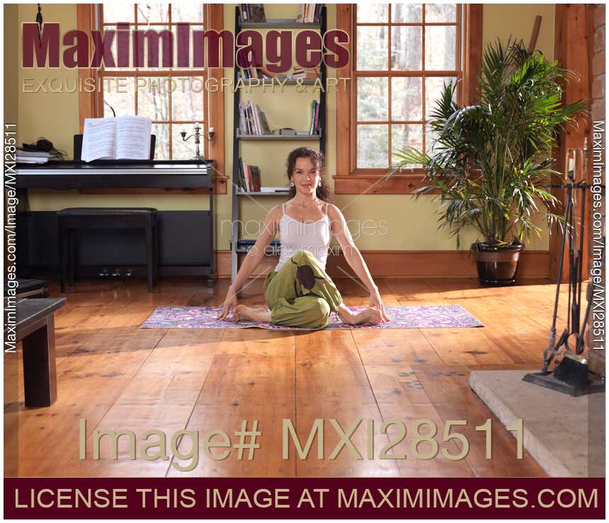 Woman practicing yoga at home on a sunny day