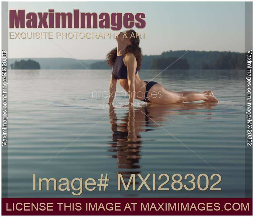 Woman practicing yoga in the water Upward Facing Dog posture