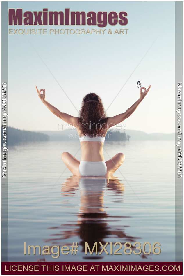 Woman practicing yoga meditation on the water with butterfly on her hand
