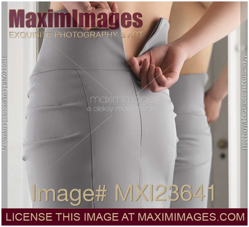 Woman Putting On a Skirt