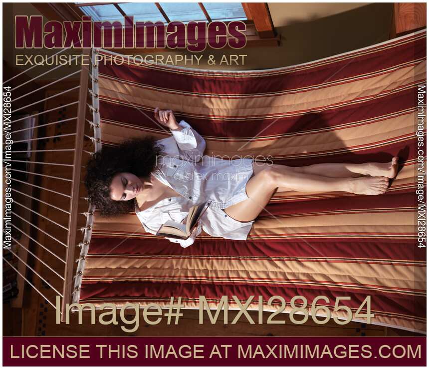 Woman reading a book in a hammock