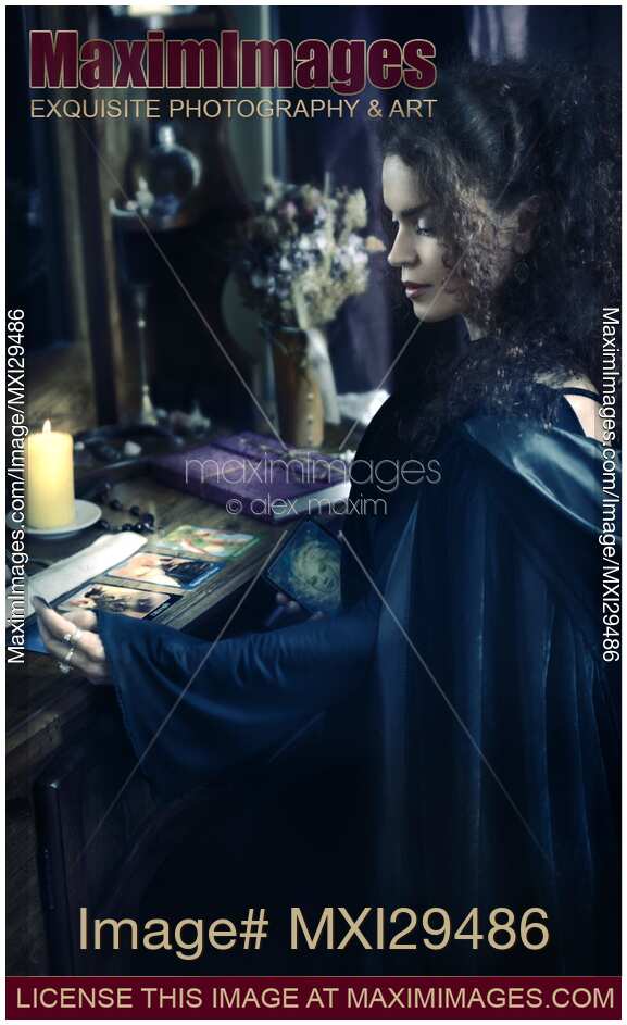 Woman reading Tarot cards at a table