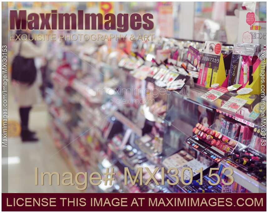 Woman shopping at makeup and cosmetics section of beauty store in Japan