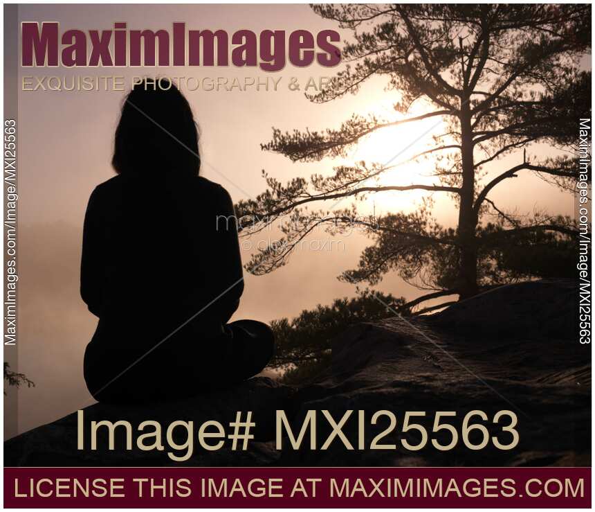 Woman silhouette over sunrise sky
