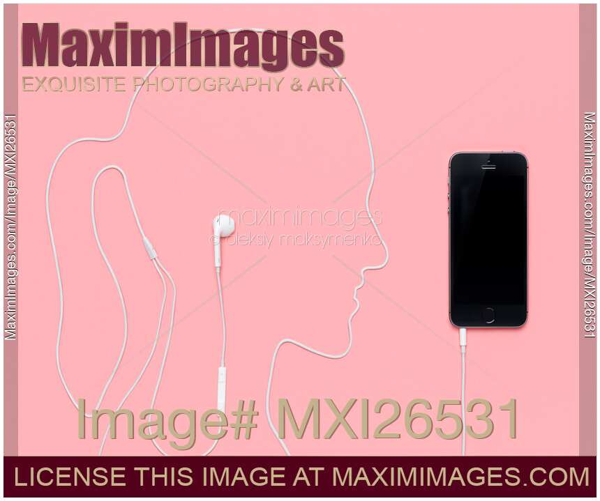 Woman silhouette with headphones plugged into iPhone