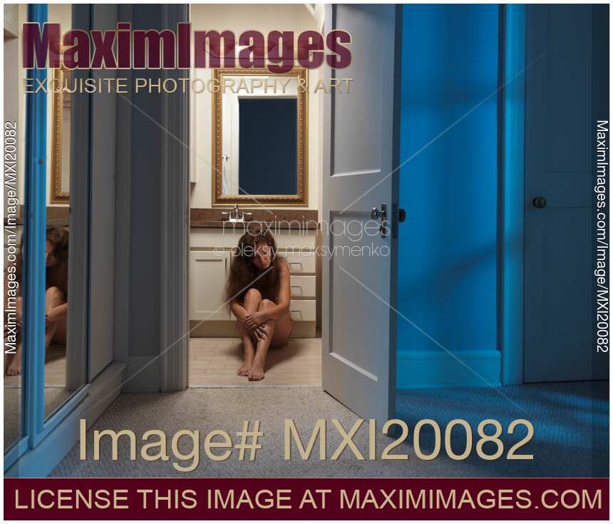 Woman Sitting on a Bathroom Floor