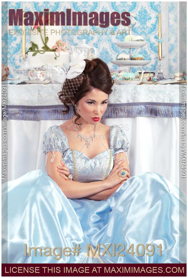 Woman sitting pouting beside a party table