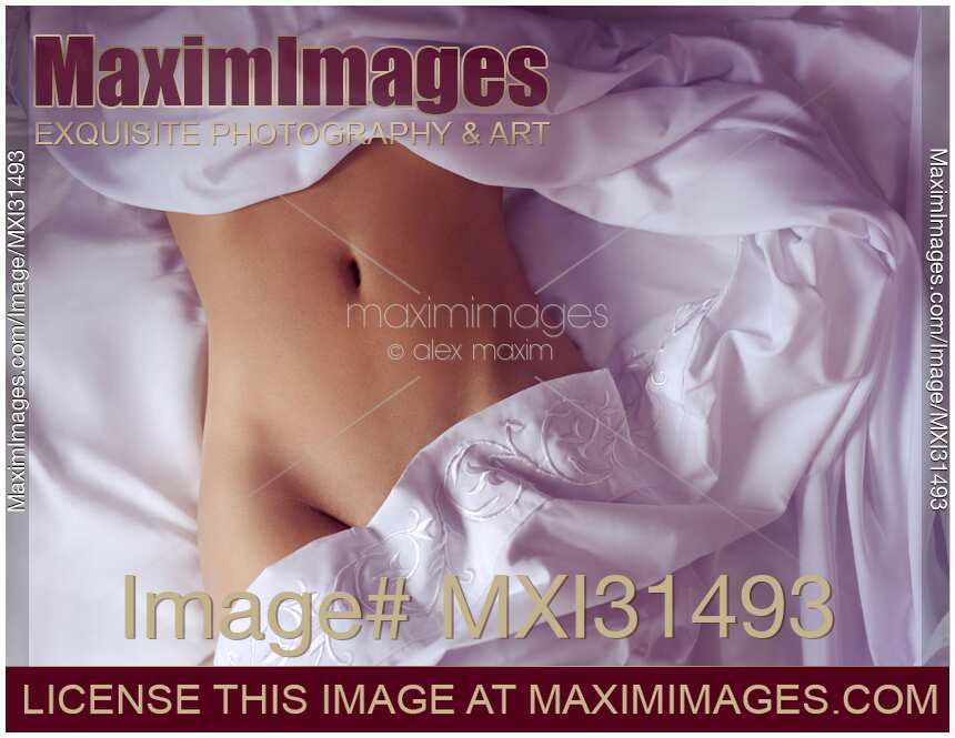 Woman sleeping naked in bed sexy closeup of her stomach