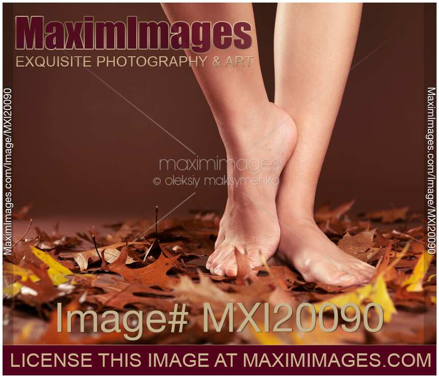 Woman Standing Barefoot on Autumn Leaves
