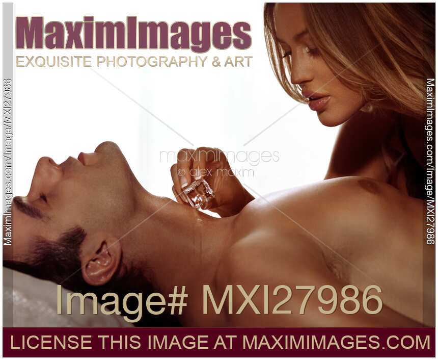 Woman touching man neck with ice cube