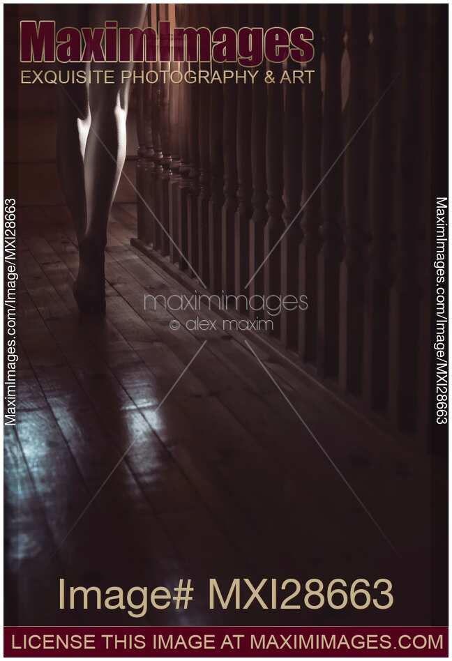 Woman walking barefoot in dark house Closeup of legs