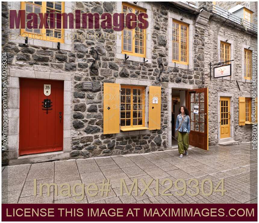 Woman walking out of Amimoc shoe store on Rue de Petit Champlain Street in Old Quebec City