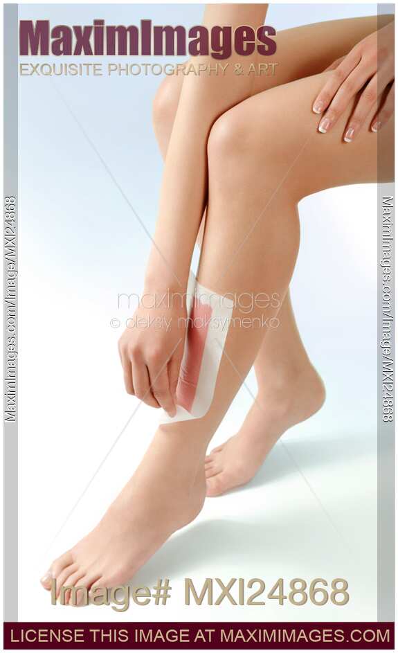 Woman waxing her legs