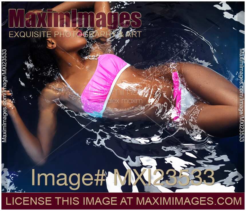 Woman Wearing Bikini Lying in Water