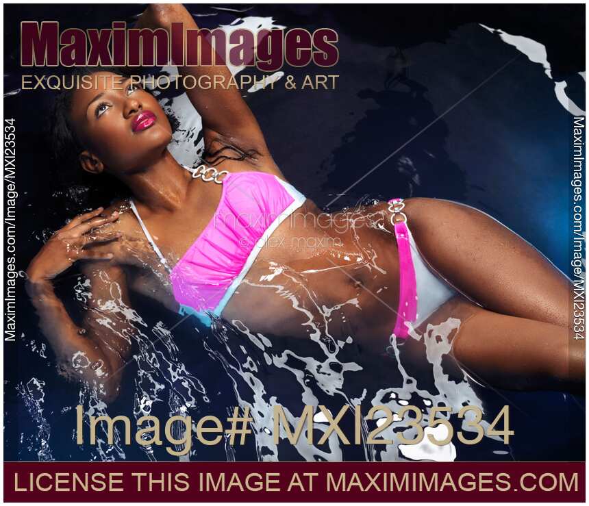 Woman Wearing Bikini Lying in Water