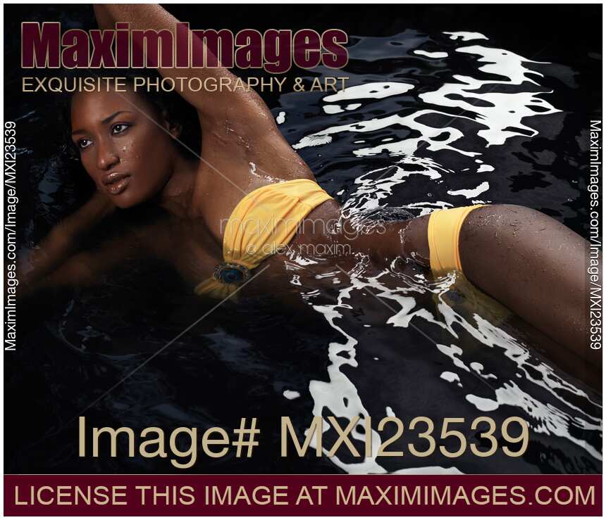Woman Wearing Bikini Lying in Water