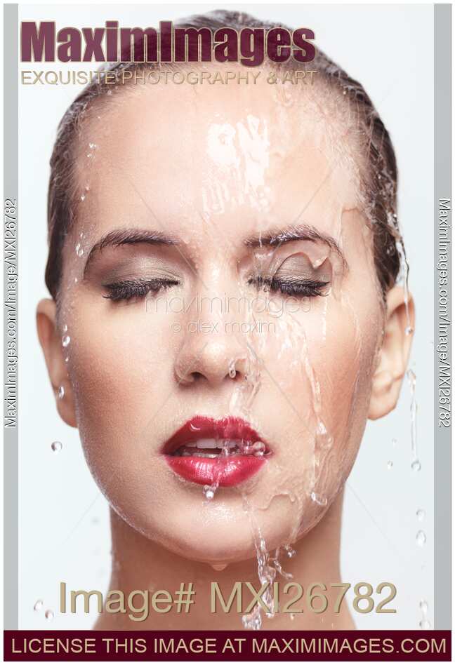 Woman wet face with makeup and lipstick and water running over it