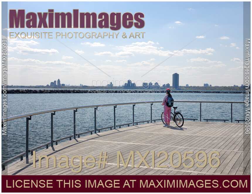 Woman with a Bicycle on a Pier