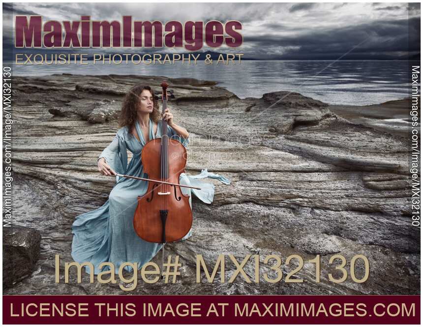 Woman with a tranquil thoughtful expression gracefully playing cello in dramatic stormy ocean shore scenery
