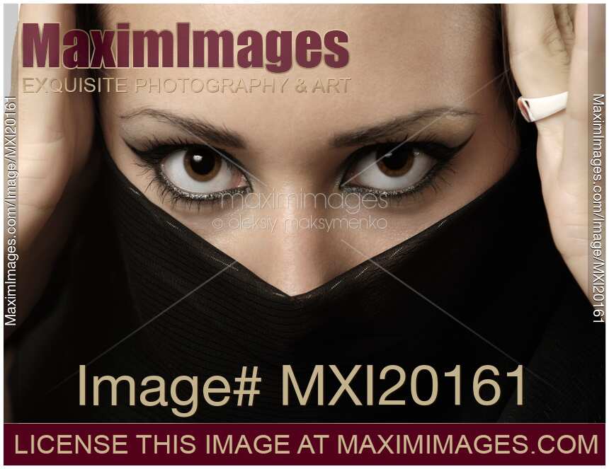 Woman with Beautiful Expressive Eyes Covering Face with Scarf