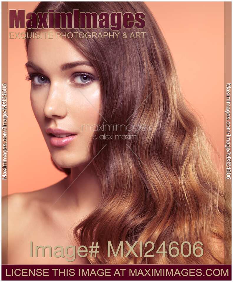 Woman with beautiful long wavy brown hair Beauty face portrait