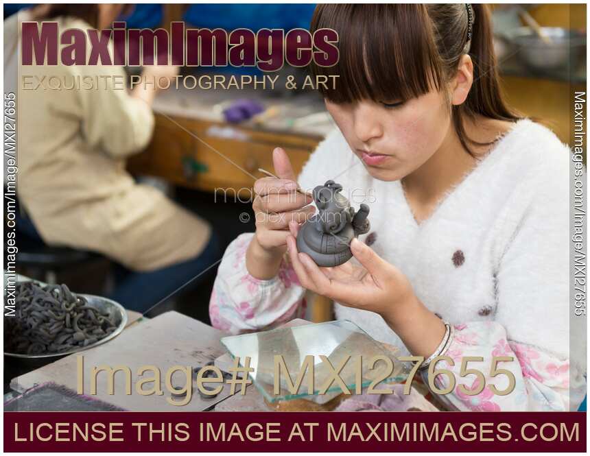 Woman working on a sculpture at a factory