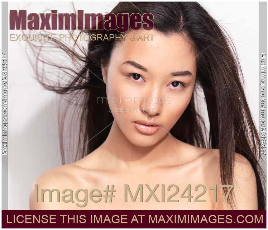 Young asian woman with flying hair
