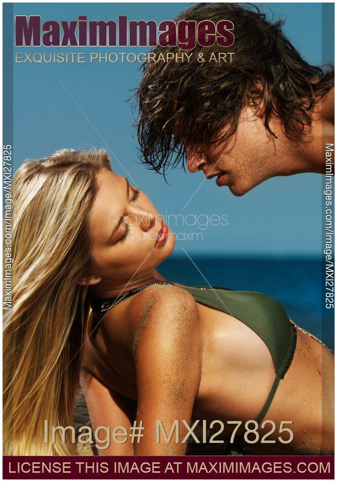 Young beautiful couple kissing on the beach