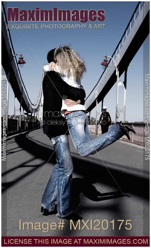 Young Couple Kissing on the Bridge