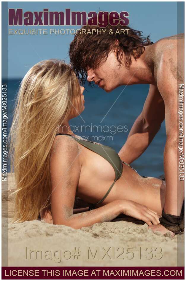 Young Couple on the Beach Kissing