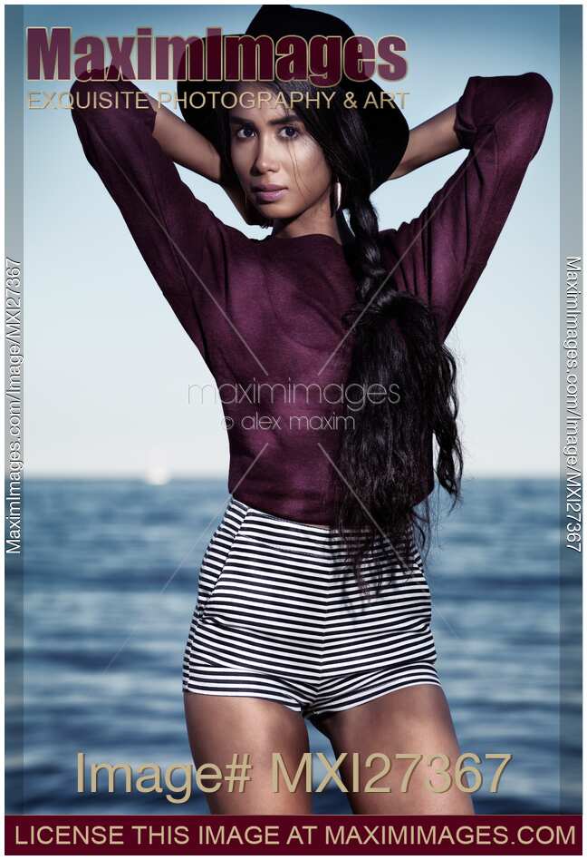 Young fashionably dressed woman at the beach