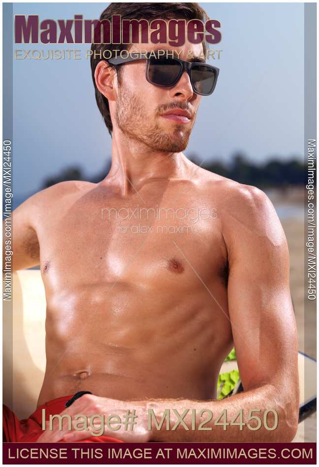 Young man in sunglasses at the beach