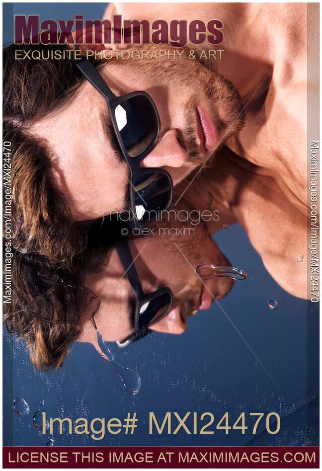 Young man in sunglasses lying in the sun
