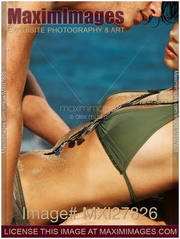 Young sensual couple kissing on the beach