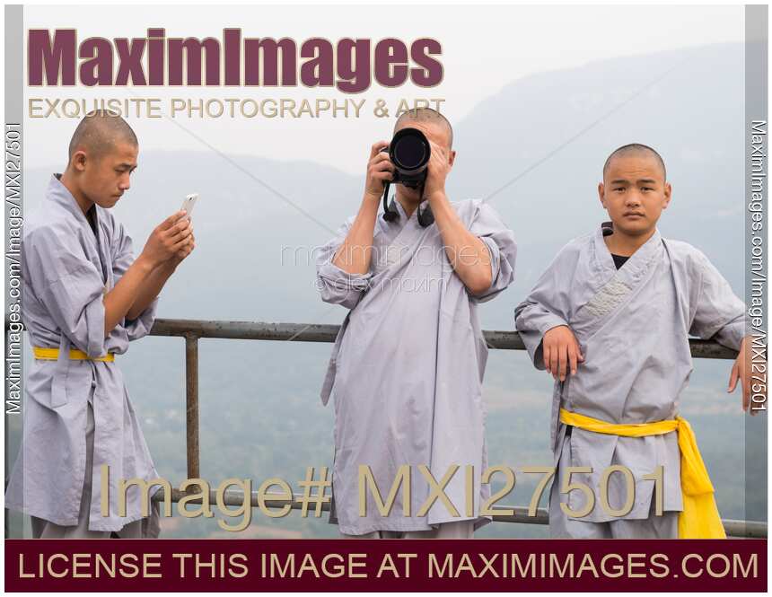 Young Shaolin disciples using technology