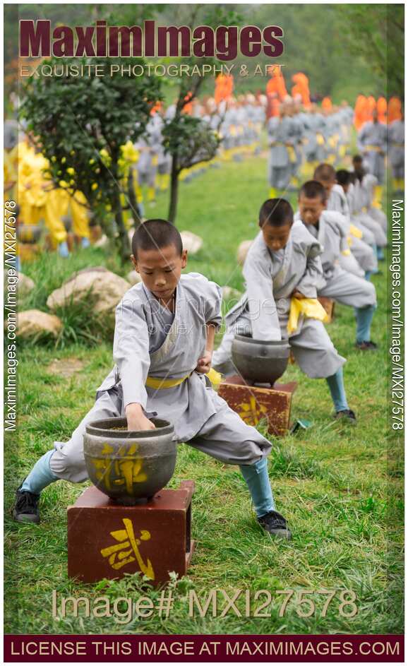 Young Shaolin Kung Fu students conditioning their fists