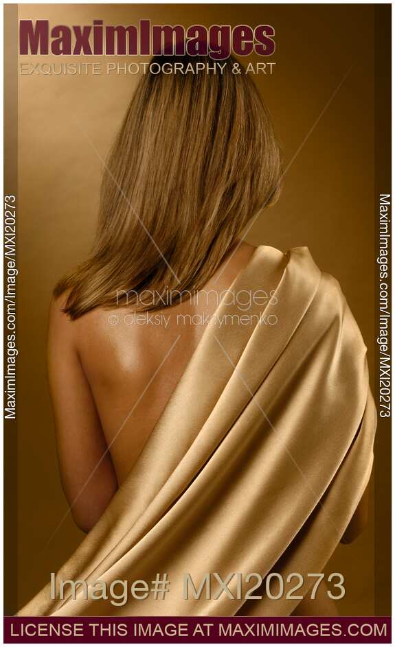 Young woman back covered with golden fabric