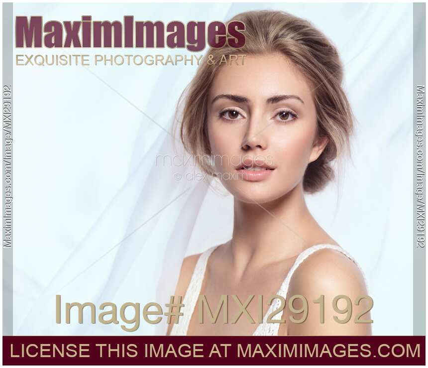 Young woman beautiful face portrait on light blue background
